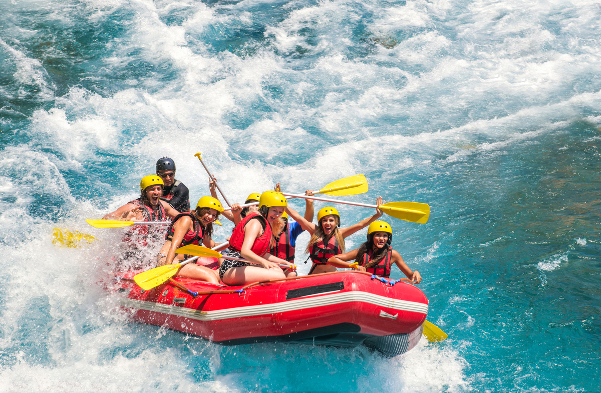 Group of people white water rafting